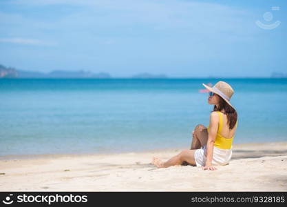 Woman tourist in yellow swimsuit and hat, happy traveler sunbathing at Paradise beach on Islands. destination, wanderlust, Asia Travel, tropical summer, vacation and holiday concept