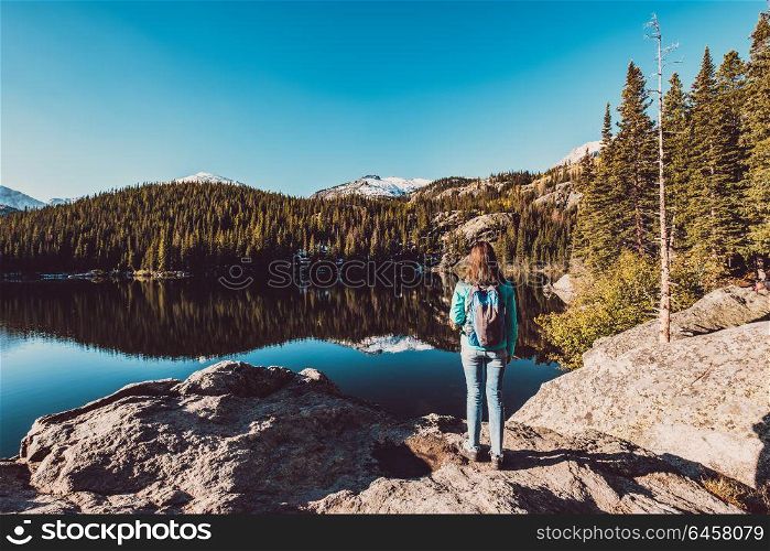 Woman tourist near Bear Lake at autumn in Rocky Mountain National Park. Colorado, USA.