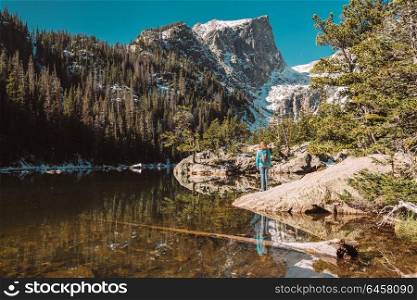 Woman tourist near Dream Lake at autumn in Rocky Mountain National Park. Colorado, USA.