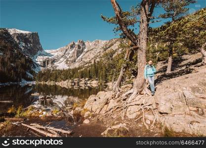 Woman tourist near Dream Lake at autumn in Rocky Mountain National Park. Colorado, USA.