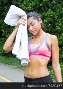 Woman towels off and rests after running