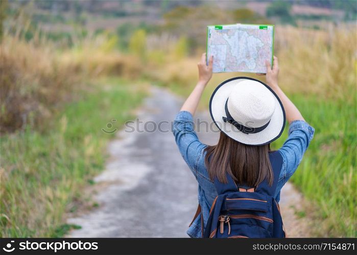 woman traveler searching direction on location map while traveling