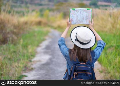 woman traveler searching direction on location map while traveling