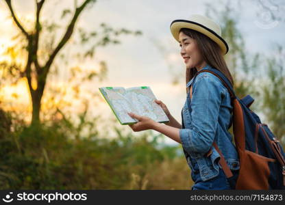 woman traveler searching direction on location map while traveling