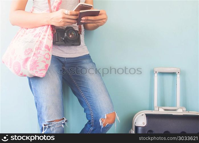 Woman traveler using smart phone and passport book with traveler. Woman traveler using smart phone and passport book with traveler suitcase, Happy and Travel lifestyle concept