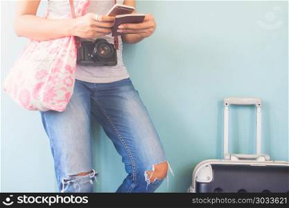 Woman traveler using smart phone and passport book with traveler. Woman traveler using smart phone and passport book with traveler suitcase, Happy and Travel lifestyle concept