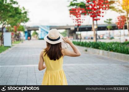 Woman Traveler with yellow dress visiting in Da Nang. Tourist sightseeing at love lock bridge. Landmark and popular. Vietnam and Southeast Asia travel concept