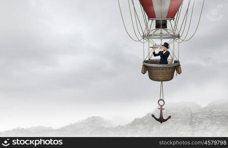 Woman traveling in aerostat. Young businesswoman flying hight in sky in colorful aerostat