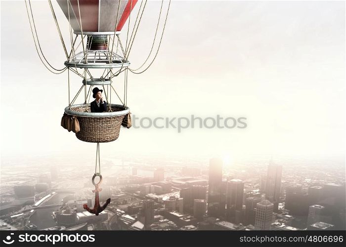 Woman traveling in aerostat. Young businesswoman flying hight in sky in colorful aerostat