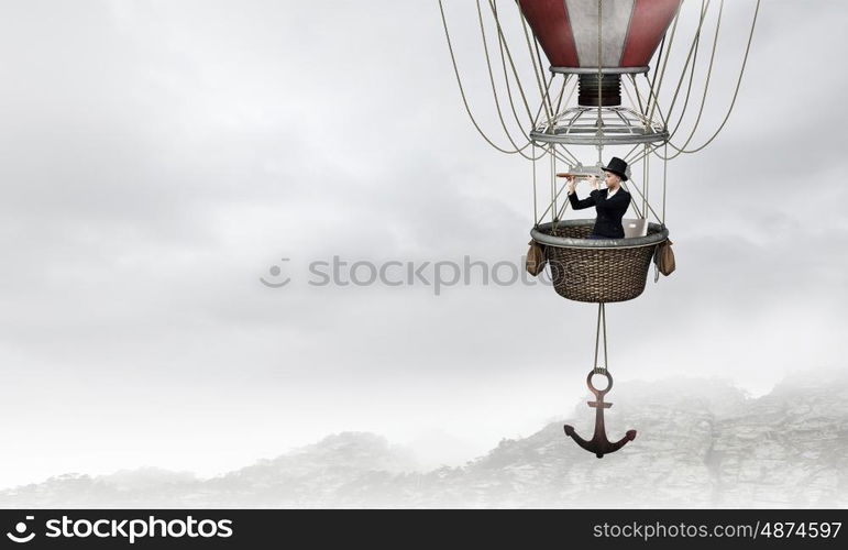 Woman traveling in aerostat. Young businesswoman flying hight in sky in colorful aerostat