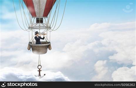 Woman traveling in aerostat. Young businesswoman flying hight in sky in colorful aerostat