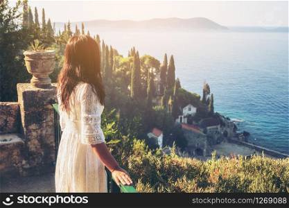 Woman traveller enjoys scenic view of Adriatic coast in Trsteno, Dalmatia, Croatia. Tourist attraction near Dubrovnik old town.