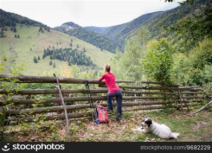 woman trekking with dog in the countryside