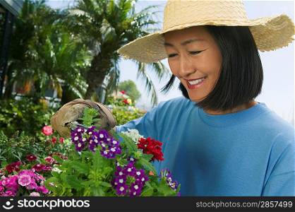 Woman Trimming Flowers