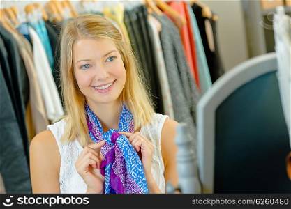 Woman trying on a colourful scarf
