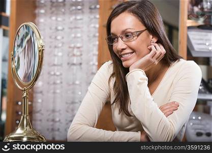 Woman trying on eyeglasses in store
