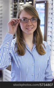 Woman Trying On Glasses In Opticians