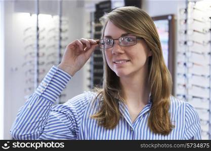 Woman Trying On New Glasses In Opticians