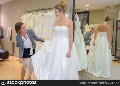 Woman trying on wedding dress