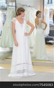 woman trying wedding dress in boutique