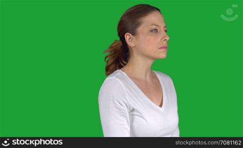 Woman turns and stares expressionless (Green Key)