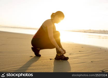 Woman tying her shoes and getting ready for train