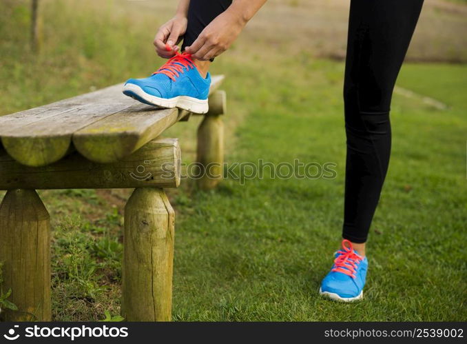 Woman tying her shoes and getting ready for train