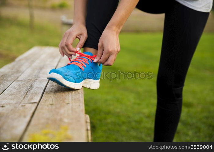 Woman tying her shoes and getting ready for train