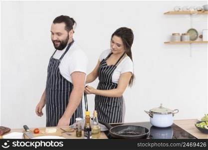 woman tying man apron
