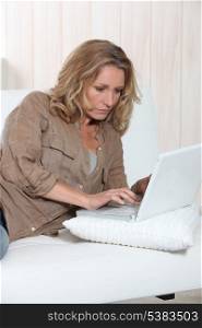 Woman typing at a laptop