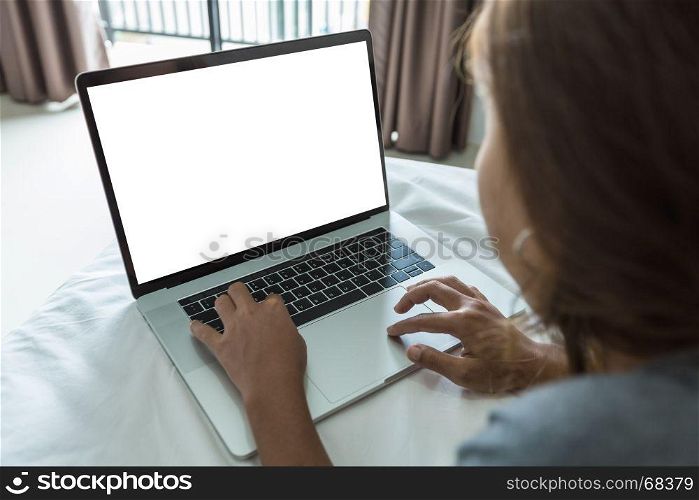 woman typing laptop keyboard white screen on bed inside room