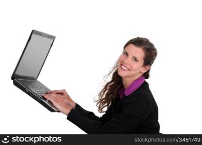 Woman typing on a laptop in mid-air