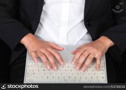 Woman typing on laptop keyboard