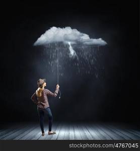 Woman under rain. Young woman in casual holding raining cloud on rope