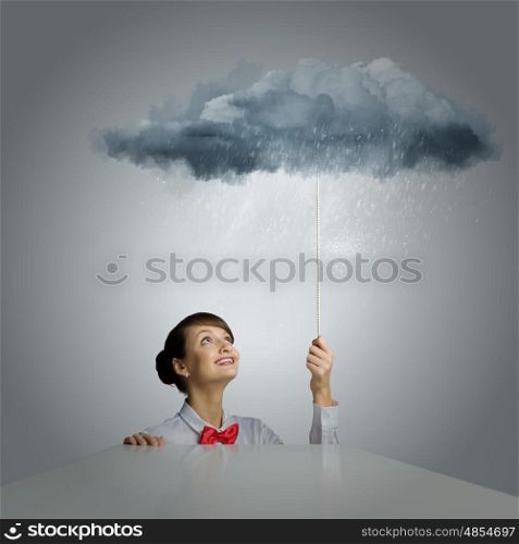 Woman under rain. Young woman looking above at raining cloud