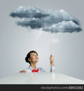 Woman under rain. Young woman looking above at raining cloud
