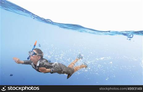 Woman under water. Businesswoman in suit and mask swimming under water