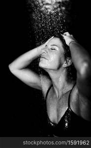 Woman under Water Drops. Showering, Black Background.. Woman under the Shower