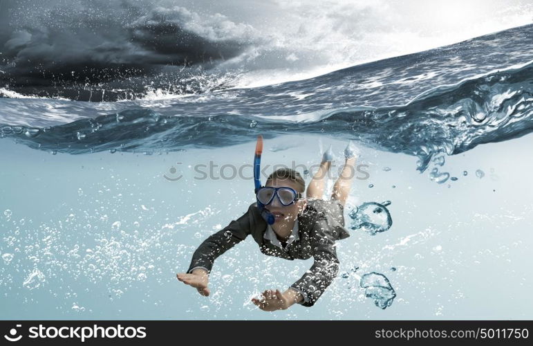 Woman under water. Young businesswoman in suit and diving mask swimming under water