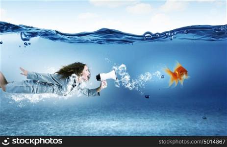 Woman underwater. Young businesswoman in suit swimming in crystal blue water