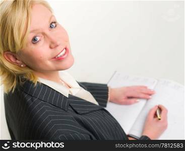 Woman use her calendar and looking toward, white background.