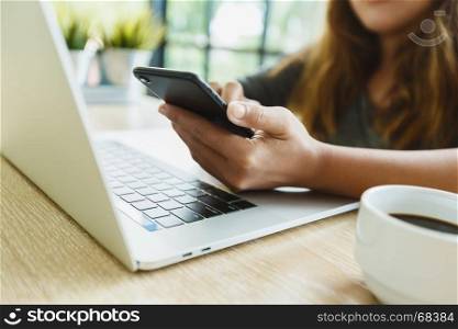 woman use smartphone on desk in office place