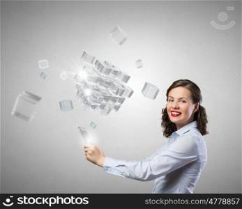 Woman use tablet device. Confident young businesswoman working on digital tablet pc and 3D cube illustartion