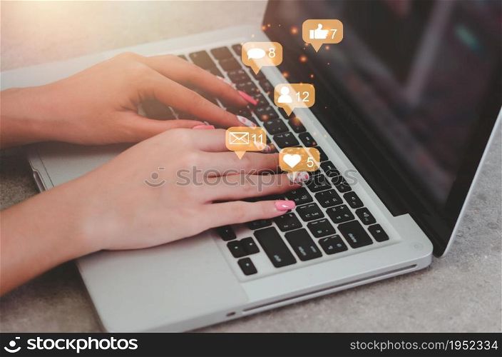 woman uses computer laptop social media for internet marketing. Concept of business technology with notification icons of like, message, email, comment