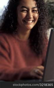 Woman Using a Computer and Smiling