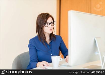 Woman using a desk computer at office