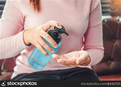 Woman using a hand sanitizer alcohol gel to wash hands to prevent viruses and diseases at home