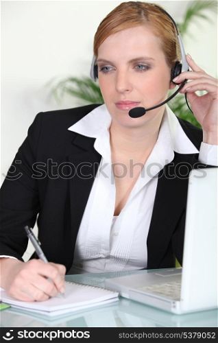 Woman using a headset at her laptop