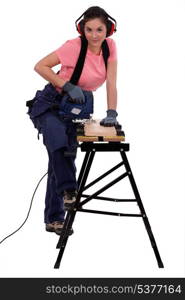 Woman using an electric jigsaw