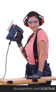 Woman using an electric saw